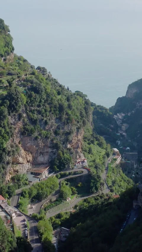 Vertical Drone View of Dramatic Mountain Valley with Winding Scenic Road Vídeos de archivo 331118086