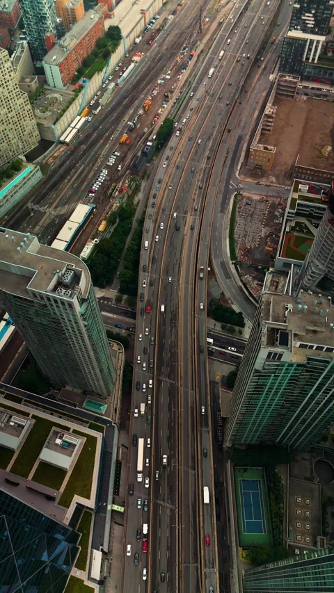 Vertical drone view flying above Gardiner Expressway traffic between downtown Stock Footage 328213523