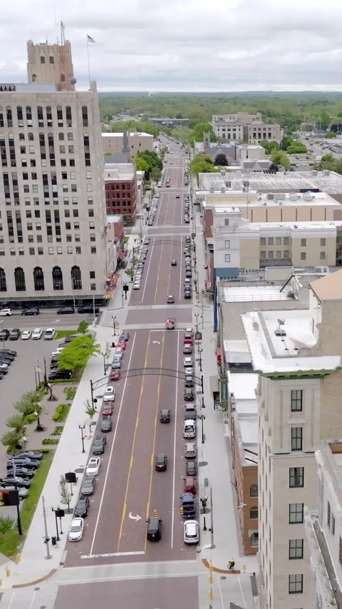 Vertical drone view hovering above Flint Michigan downtown skyline Stock Footage 332076528