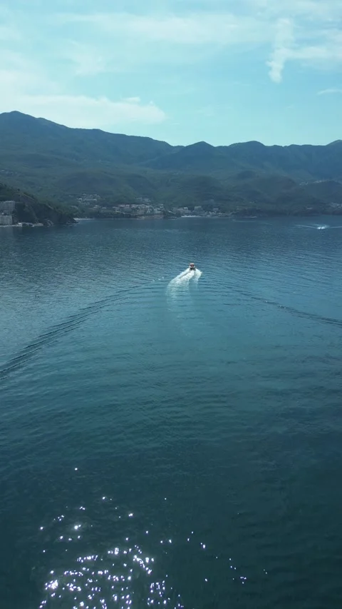 Vertical drone view of a motorboat on the Adriatic Sea in Montenegro Stock Footage 338027687
