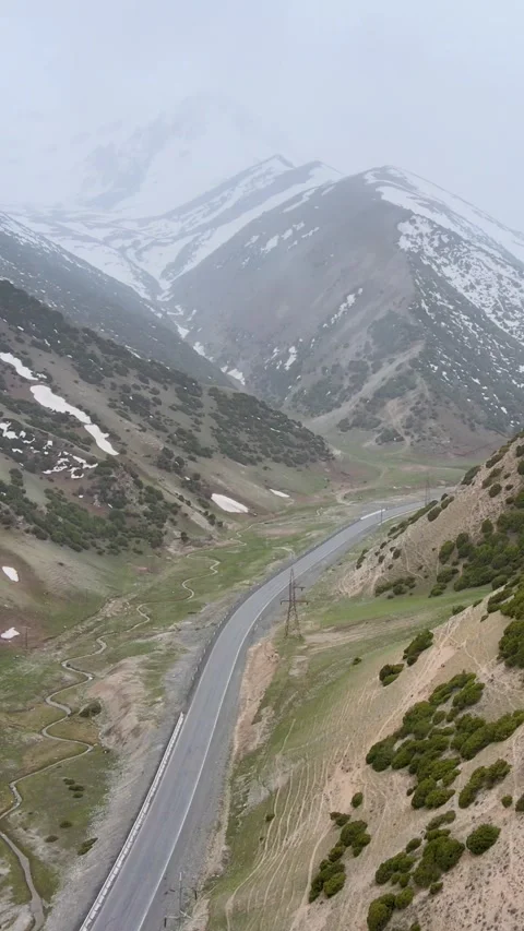 Vertical Drone View of Pamir Highway Mountain Road in Light Snowfall Stock Footage 337832949