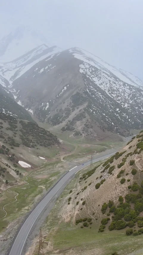 Vertical Drone View of Pamir Highway Through Snowy Mountain Valley 스톡 동영상 337832953