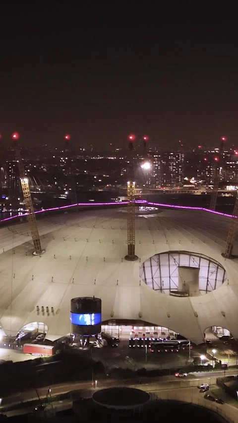 Vertical drone view panning backwards from the O2 Arena in Greenwich in London Stock Footage 306585525
