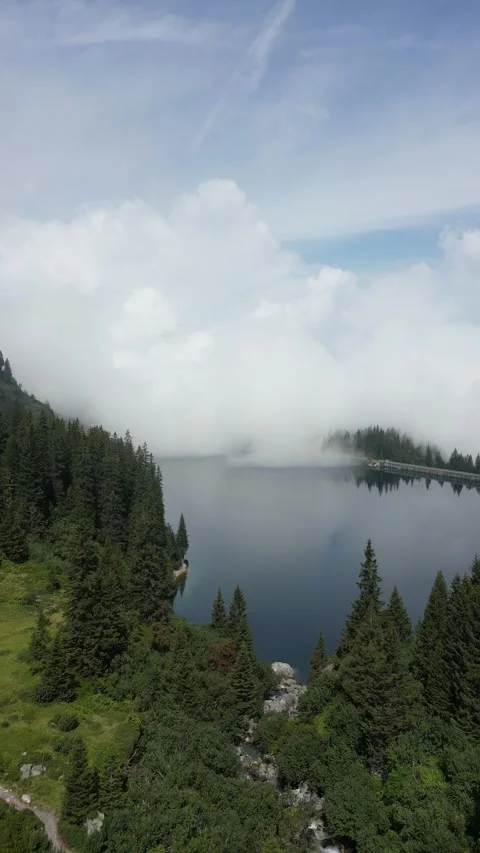 Vertical drone view of remote alpine lake in high mountain landscape Stock Footage 330749698