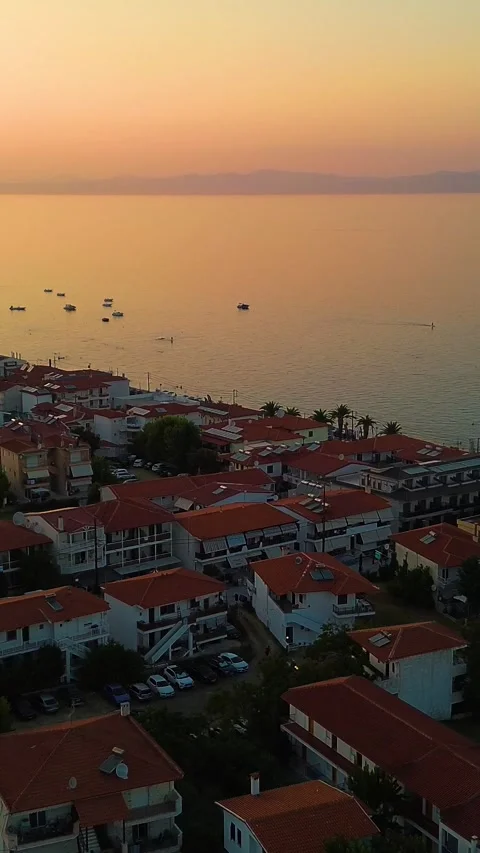 Vertical Drone View Rising Over Beach and Coastal Town at Sunset Stock Footage 342238088