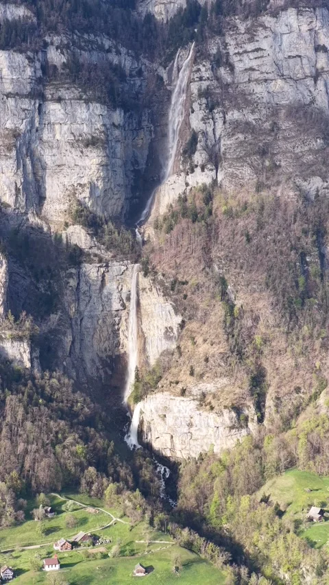 Vertical drone view Seerenbach Falls Switzerland alpine cliff waterfall Stock Footage 334092001
