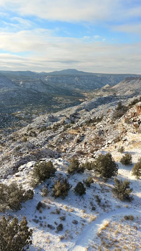 Vertical Drone View of Vast Snowy Canyon and Distant Peaks in Los Alamos New Stock Footage 328794031