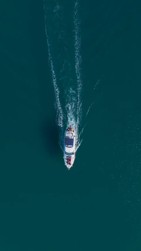 Vertical Drone View White Yacht Near Breakwater with Lighthouse and Small Boats Stock Footage 341761858