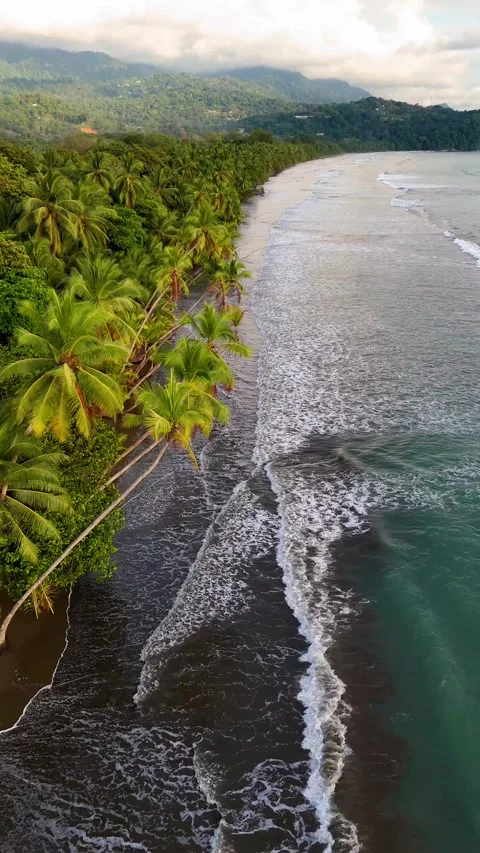 Vertical Drone of Waves and Clouds at Playa Uvita at sunset Stock Footage 328598252