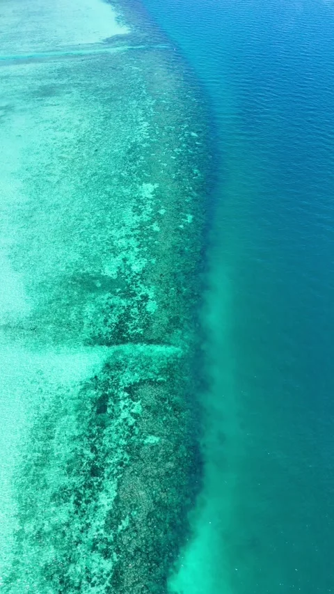 Vertical drone zooming over turquoise and deep blue waters, Koh Ngai – 4K Stock Footage 325022372
