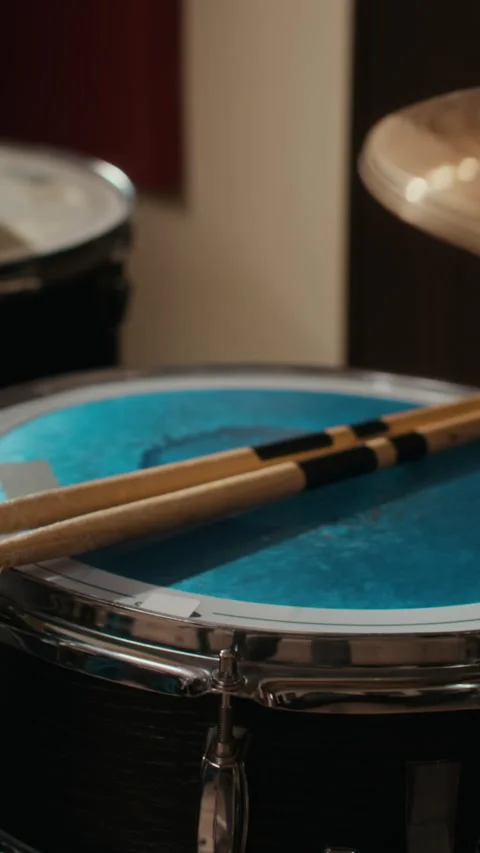 Vertical of Drumsticks Resting on Snare Drum in Professional Music Studio Stock Footage 336379098
