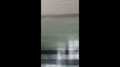 Vertical - The dust on the glass coffee table is wiped away with a damp cloth. Stock Footage 330036224