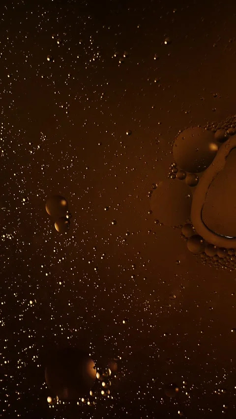 Vertical dynamic light change on amber oil and water bubbles background Stock Footage 341825075