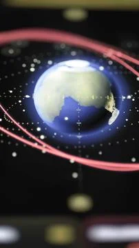 Vertical Earth model displays red orbital trajectories Stock Photos