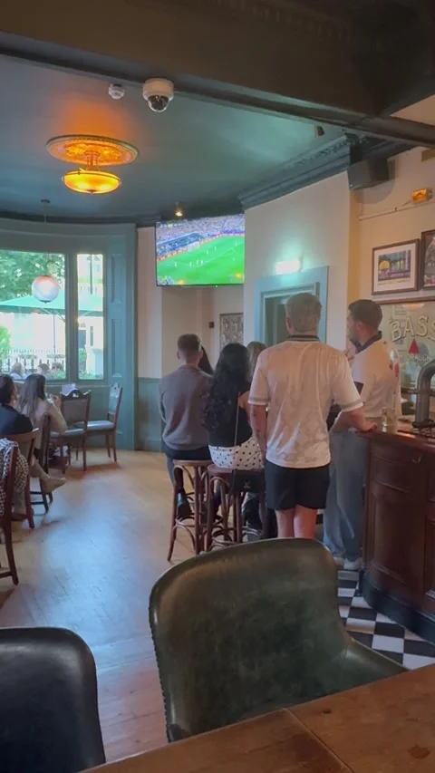 Vertical editorial shot of people watching football match in London pub Stock Footage 337160364