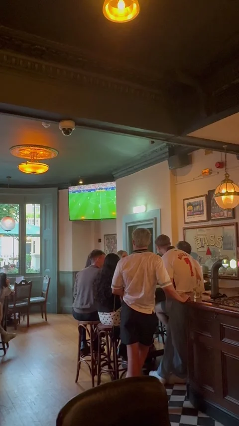 Vertical editorial shot of people watching football match in London pub Stock Footage 337160391