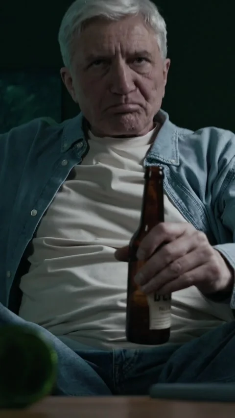 Vertical of Elderly Man Abusing Alcohol While Watching TV at Home Alone 스톡 동영상 300588447