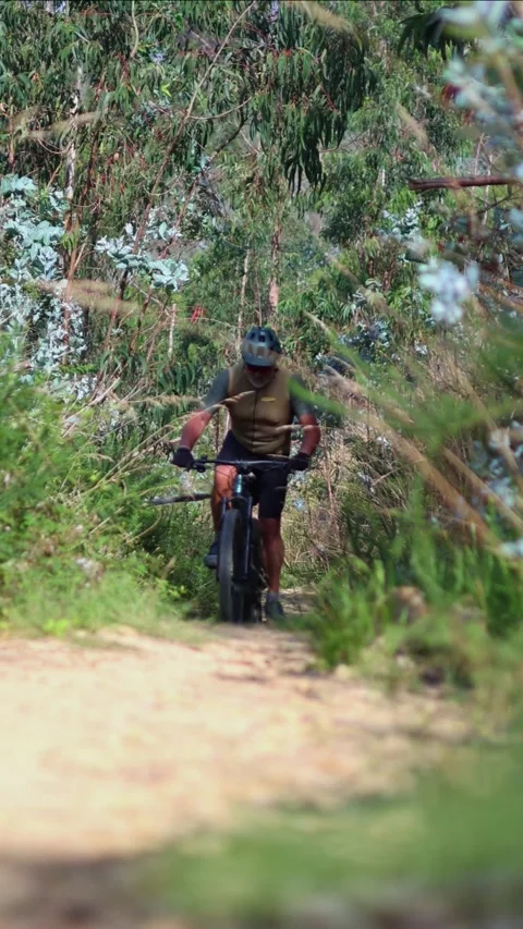 Vertical Elderly man riding electric mountain bike on trail Stock Footage 312067632