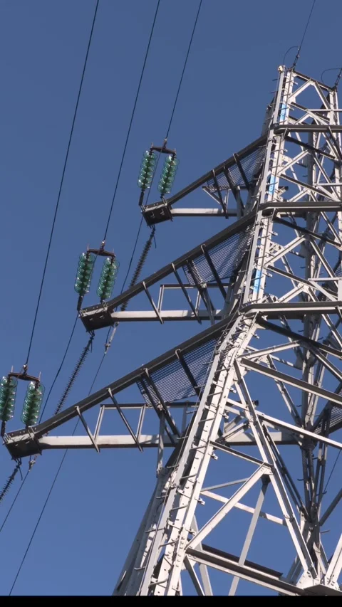 Vertical - electricity pole with strain insulators against blue sky Stock Footage 306041898