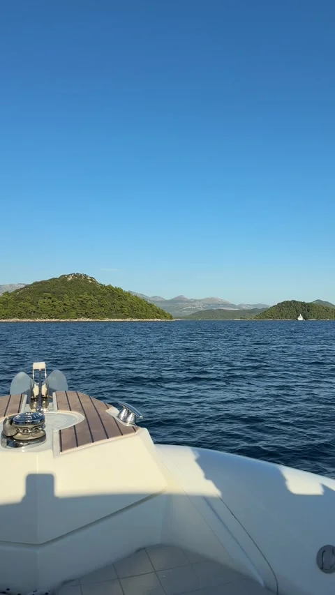 Vertical elegant view of boat on Adriatic water with distant hills Stock Footage 319407347