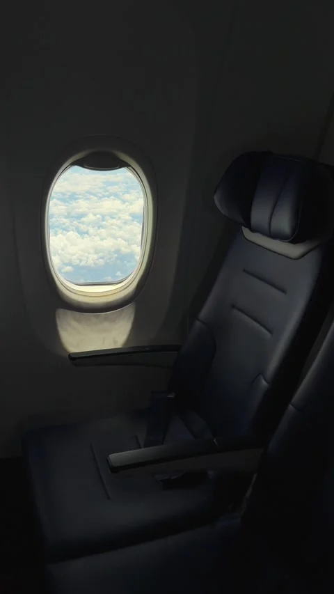 Vertical Empty Airplane Seat by Window with Clouds view during transcontinental Vídeo Stock 342898752