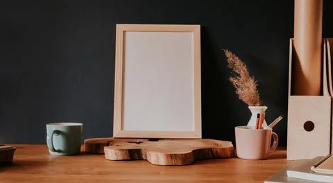 Vertical empty frame stanting on wooden slice Stock Photos
