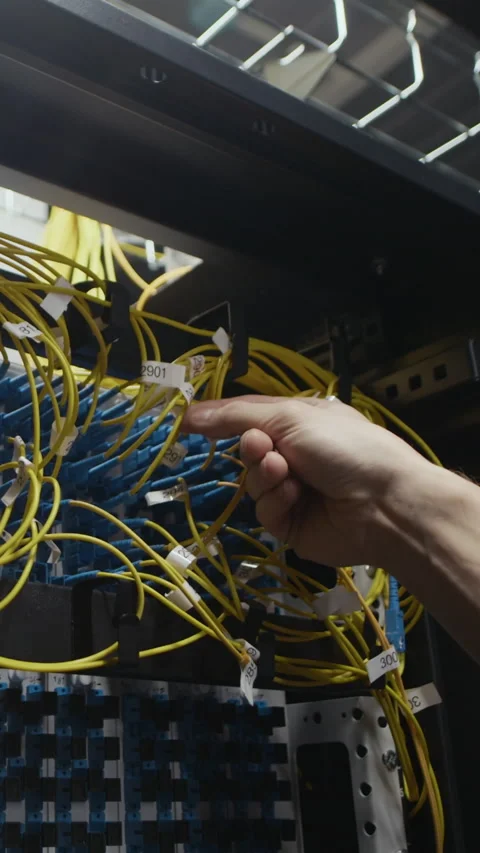 Vertical of Engineer Hand Adjusting Ethernet Cables in Data Center Rack Stock Footage 330541371