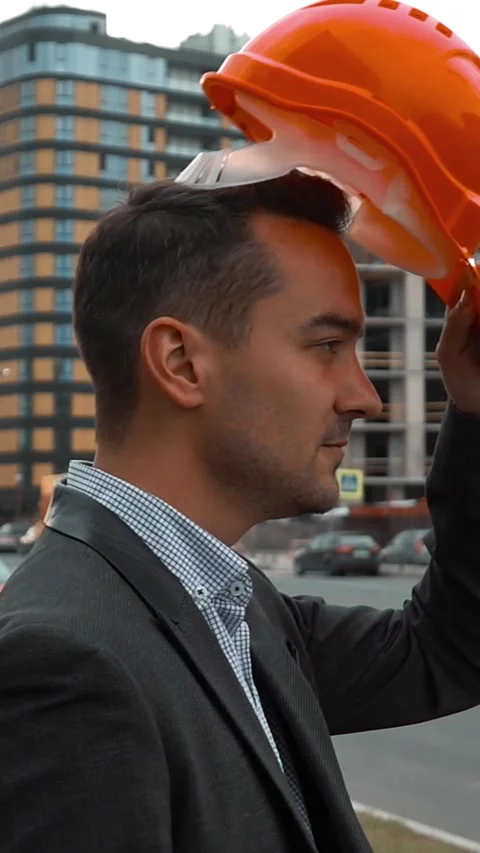 Vertical of Engineer putting on helmet Stock Footage 305513507