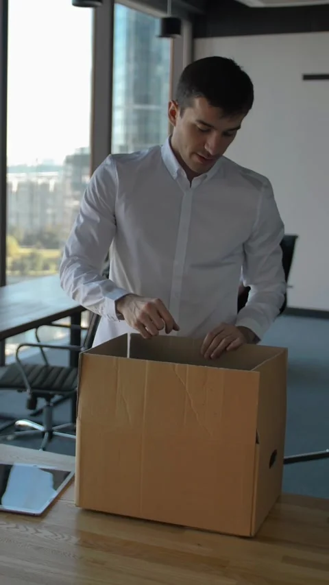 Vertical of Entrepreneur unpacking box with docs and equipment. His colleagues Stock Footage 277278958