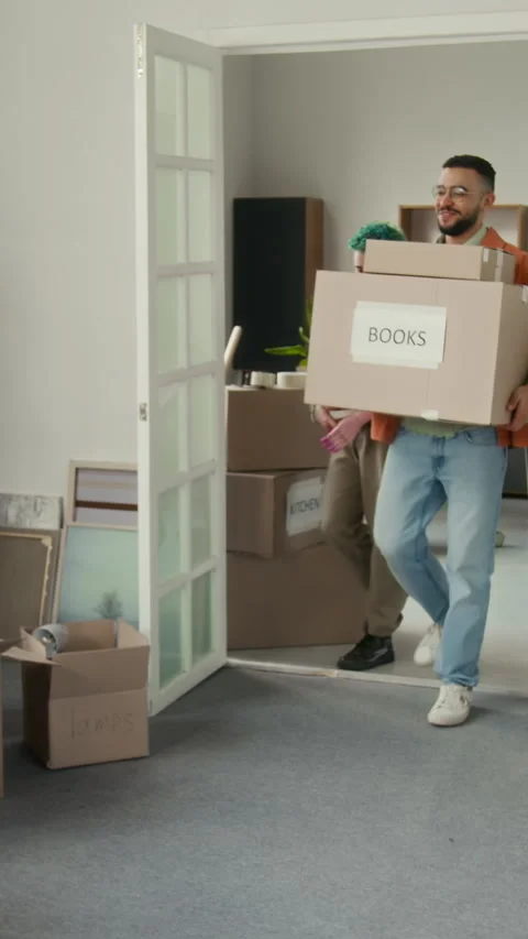 Vertical of Excited Diverse Couple Showing up in Their New Apartment Stock Footage 323297909