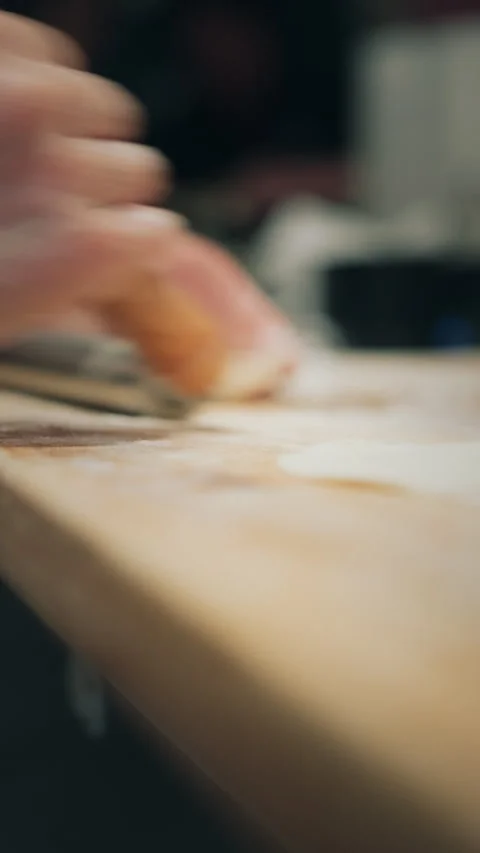Vertical extreme close-up of hands pressing dumpling dough with rolling pin Video stock 333897596
