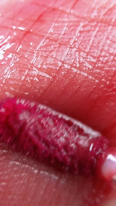 Vertical extreme close up of pink lip tint brush applicator on lip skin sur.. Stock Footage 339566743