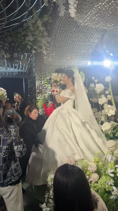 Vertical Eye-Level Medium Shot of Bride Throwing Bouquet to Excited Wedding Stock Footage 345341804