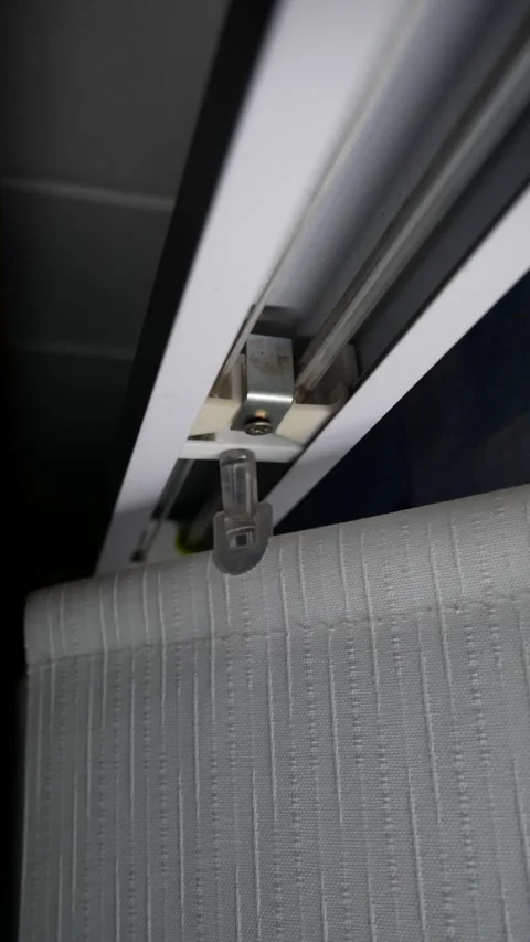 Vertical fabric blinds open or retract to create the desired lighting in the Stock Footage 297118707