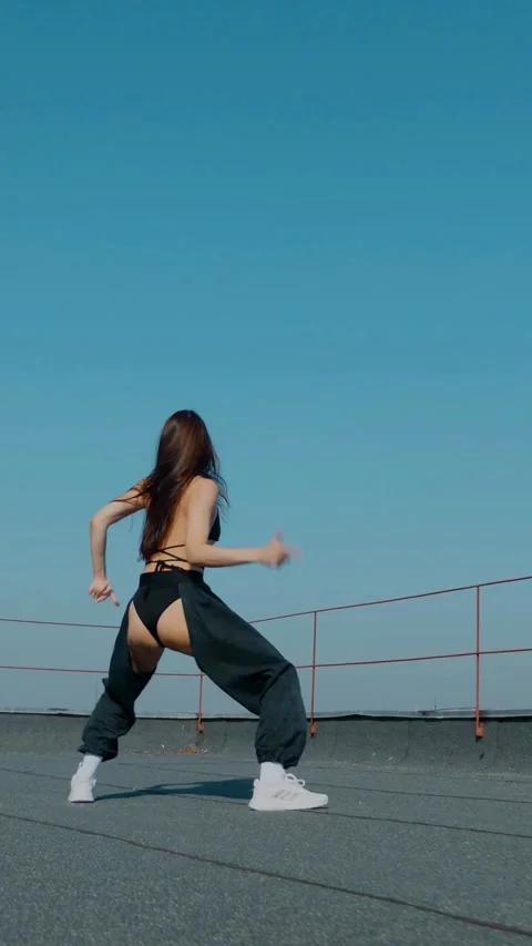 Vertical Fashion Model Dancing Sensually On Rooftop In Summer Sunshine. Stock Footage 342223385