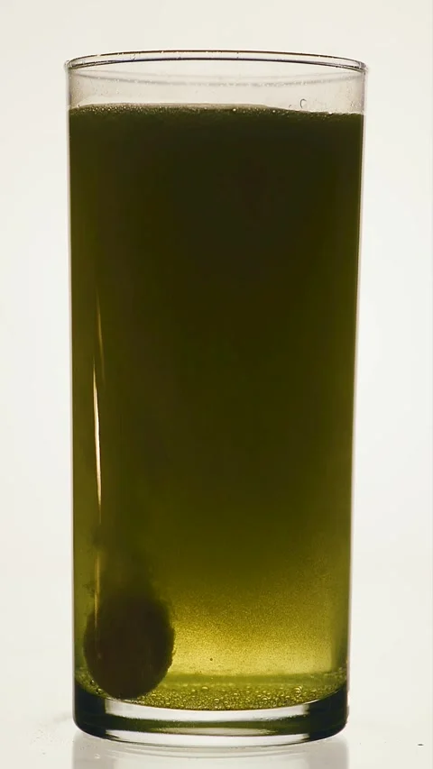 Vertical fast dissolving effervescent tablet dropping into a water glass Stock Footage 341825129