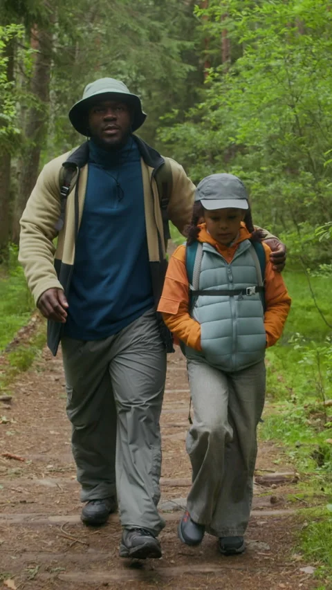 Vertical Of Father and Son Walking Along Wooden Forest Trail Stock Footage 316580007