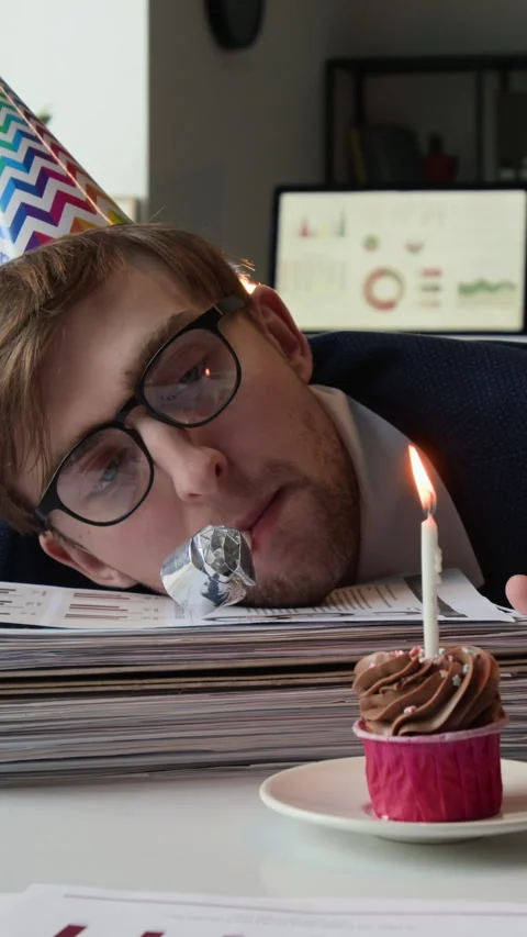 Vertical of Fatigued Employee Using Party Blower with Head on Pile of Documents Stock Footage 331528499