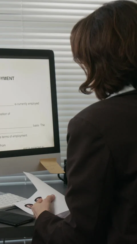 Vertical of Female Embassy Official Working with Visa Application on Computer Stock Footage 331519418