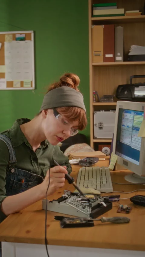 Vertical of Female Engineer Soldering Electronic Component for Hardware Repair Stock Footage 341430525