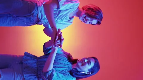 Vertical female friendship hands unity neon light Stock Footage 232719074