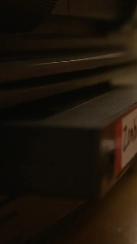 Vertical of Female Hand Inserting Retro VIdeo Tape into Vintage VCR Player Stock Footage 337926932