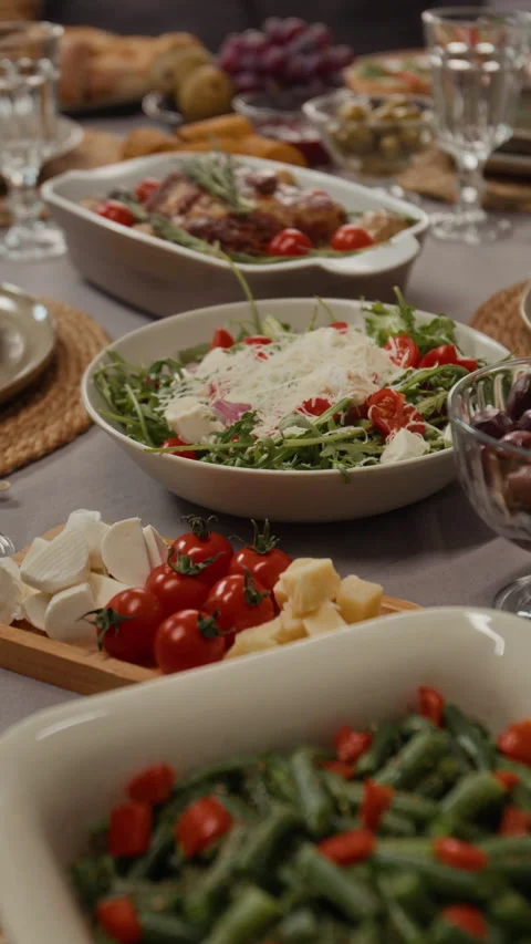 Vertical of Festive Dinner Table Filled with Delicious Food Dishes Stock Footage 340339330