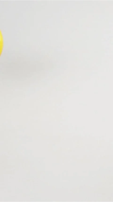 Vertical of Few lemons falling down on white wet surface Stock Footage 305516306