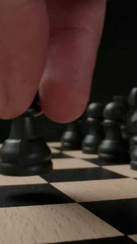 Vertical of The first standard move by chess black pawn on chess board Stock Footage 276856093