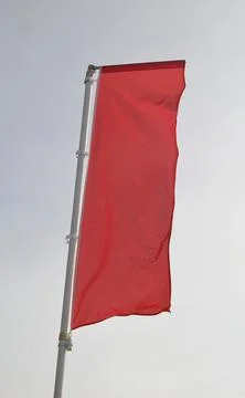 Vertical flag made of empty red fabric without inscriptions Stock Photos