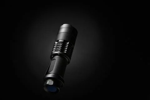 Vertical flashlight on dark background illuminated from side for dramatic c.. Stock Photos