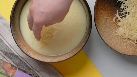 Vertical flat lay food video: the cook ads crated cheese the soup with noodles Video stock 184394983