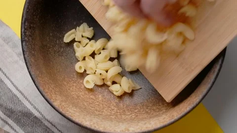 Vertical flat lay recipe: adding noodles to the bowl Stock Footage 184394378