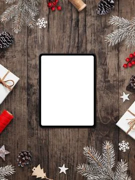 Vertical flat lay with tablet and blank screen on rustic wooden background .. Stock Photos